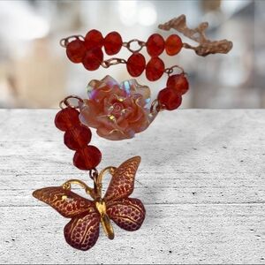 Handmade orange flower and butterfly car charm.
